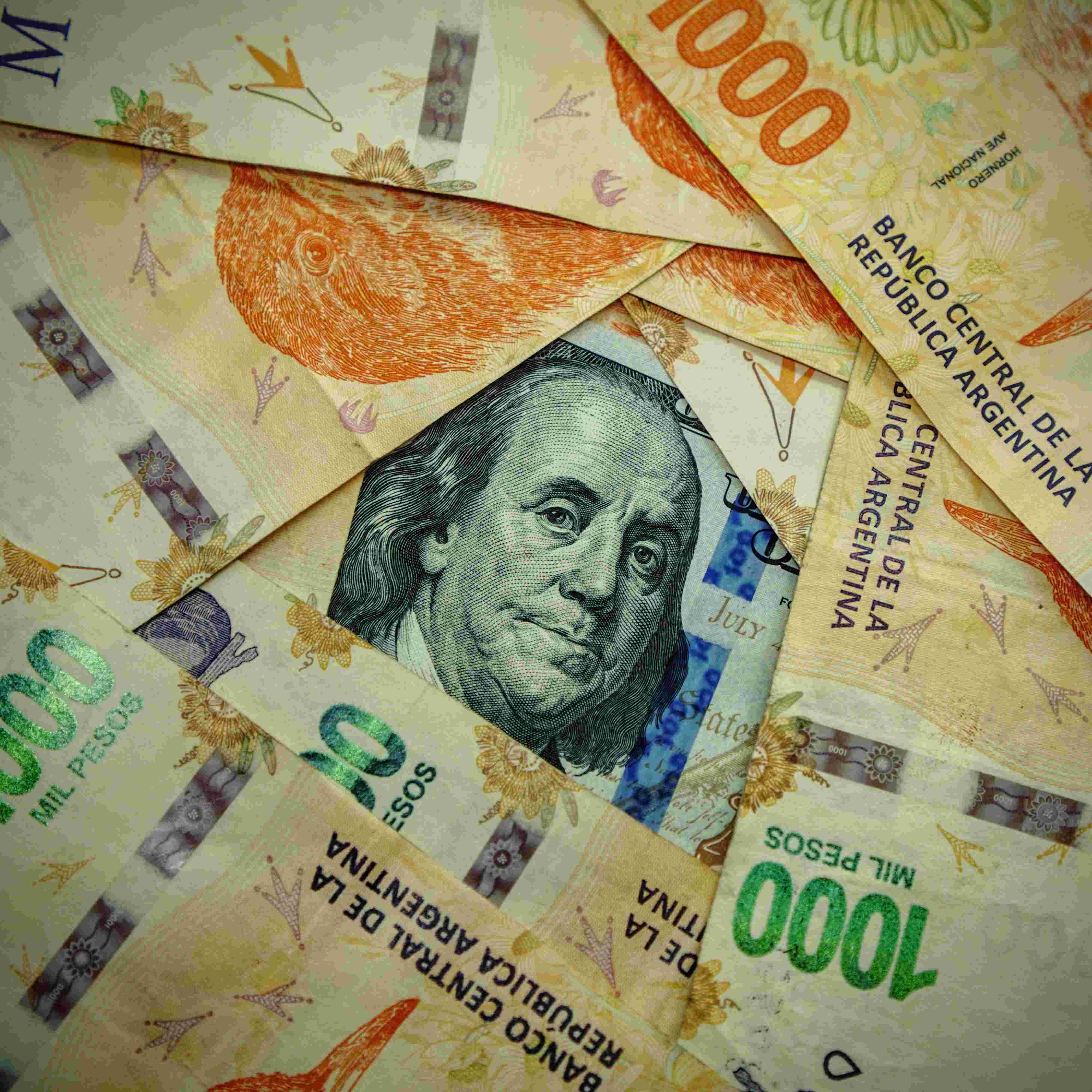 Will the Argentine government increase (or remove entirely) the monthly limit on individual dollar purchases to at least USD 100,000 by December 31, 2025?